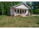 Charming exterior featuring white siding, a front porch, and manicured landscaping at 1012 W Carroll St, Cherryville, NC 28021