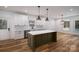 Well-lit kitchen featuring an island, stainless steel dishwasher, modern cabinets, and sleek countertops at 1012 W Carroll St, Cherryville, NC 28021