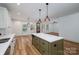 Open-concept kitchen featuring an island, stainless steel appliances, and modern pendant lighting at 1012 W Carroll St, Cherryville, NC 28021