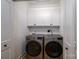 Bright laundry room features a washer and dryer set with white cabinets above for organized storage at 1012 W Carroll St, Cherryville, NC 28021