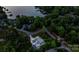 An aerial view of a lakefront property with a pool, lush landscaping, and neighborhood charm at 106 Thunder Hill Rd, Mooresville, NC 28117