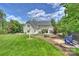 Well-maintained backyard with lush lawn, patio, and mature trees offers a private outdoor space at 106 Thunder Hill Rd, Mooresville, NC 28117