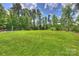 Expansive green backyard offers ample space for recreation and relaxation; a serene outdoor retreat at 106 Thunder Hill Rd, Mooresville, NC 28117
