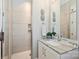 Modern bathroom with a glass-enclosed shower and a sleek vanity featuring granite countertops and stylish decorative accents at 106 Thunder Hill Rd, Mooresville, NC 28117