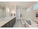 Elegant bathroom with double vanity, walk-in shower, and soaking tub; modern fixtures and tasteful decor at 106 Thunder Hill Rd, Mooresville, NC 28117