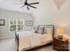Cozy bedroom featuring a queen-sized bed, modern ceiling fan, and soft natural lighting for a relaxing retreat at 106 Thunder Hill Rd, Mooresville, NC 28117