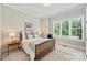 Comfortable bedroom with a rustic wooden bed frame, soft natural lighting, and neutral color scheme for a relaxing ambiance at 106 Thunder Hill Rd, Mooresville, NC 28117