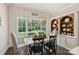 Bright dining room with large windows, stylish lighting, and built-in shelving for displaying decorative items at 106 Thunder Hill Rd, Mooresville, NC 28117