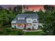 Stately two-story home featuring a covered front porch and lush landscaping against a backdrop of mature trees at 106 Thunder Hill Rd, Mooresville, NC 28117
