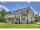 Beautifully landscaped two-story home with a welcoming front porch and meticulously maintained lawn at 106 Thunder Hill Rd, Mooresville, NC 28117