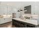 A gourmet kitchen featuring stainless steel appliances, a center island with seating, and modern lighting fixtures at 106 Thunder Hill Rd, Mooresville, NC 28117