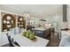 Open-concept kitchen and dining area with stainless steel appliances, island seating, and hardwood floors at 106 Thunder Hill Rd, Mooresville, NC 28117