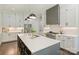 A gourmet kitchen featuring stainless steel appliances, a center island with seating, and modern lighting fixtures at 106 Thunder Hill Rd, Mooresville, NC 28117