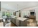 Open-concept kitchen and dining area with stainless steel appliances, island seating, and hardwood floors at 106 Thunder Hill Rd, Mooresville, NC 28117