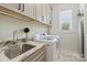 Functional laundry room with modern appliances, granite countertops, and ample cabinet space for efficient chore management at 106 Thunder Hill Rd, Mooresville, NC 28117