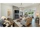 Inviting living area featuring a linear fireplace, comfortable seating, and seamless flow to the outdoor patio at 106 Thunder Hill Rd, Mooresville, NC 28117