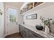 Well-organized mudroom featuring stylish gray cabinets, granite countertops, decorative baskets, and ample natural light at 106 Thunder Hill Rd, Mooresville, NC 28117