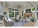 Cozy patio with a brick fireplace, comfortable seating, and sliding glass doors at 106 Thunder Hill Rd, Mooresville, NC 28117