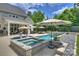 A luxurious pool and spa with patio area offers relaxation and entertainment in this home's backyard at 106 Thunder Hill Rd, Mooresville, NC 28117