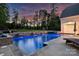 The backyard boasts a stunning in-ground pool with stone accents and relaxing water features at 106 Thunder Hill Rd, Mooresville, NC 28117