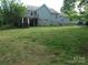 Expansive backyard featuring a wooden deck and lush green lawn at 109 Gatwick Ct, Statesville, NC 28677