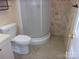 Bathroom featuring tiled floor, shower, and wall accents at 109 Gatwick Ct, Statesville, NC 28677