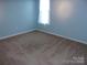 Carpeted bedroom with light blue walls and bright natural light at 109 Gatwick Ct, Statesville, NC 28677