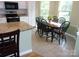 Well-lit kitchen and breakfast area featuring white cabinets, granite countertops, and stainless appliances at 109 Gatwick Ct, Statesville, NC 28677
