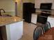 Bright kitchen featuring granite countertops, stainless steel appliances, and white cabinetry at 109 Gatwick Ct, Statesville, NC 28677