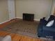 Inviting living room with hardwood floors, a fireplace, and cozy blue sofa at 109 Gatwick Ct, Statesville, NC 28677