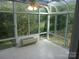 Bright sunroom featuring tiled floors, ceiling fan, and large windows offering verdant views at 109 Gatwick Ct, Statesville, NC 28677