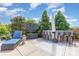 Outdoor backyard area with bar seating, a chaise lounge, and mature trees at 1098 Matchstick Sw Pl, Concord, NC 28025