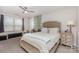 Bright bedroom with a plush bed, desk, and a decorative leafy wall accent at 1098 Matchstick Sw Pl, Concord, NC 28025