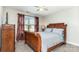 Cozy bedroom featuring a wood sleigh bed, a large window, and a ceiling fan at 1098 Matchstick Sw Pl, Concord, NC 28025