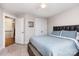 Well-lit bedroom featuring a comfortable bed, carpet flooring, and convenient closet space at 1098 Matchstick Sw Pl, Concord, NC 28025