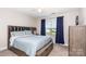 Comfortable bedroom with a plush bed, ceiling fan, and natural light from a large window at 1098 Matchstick Sw Pl, Concord, NC 28025