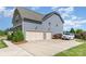 Exterior view of home with a three-car garage and a spacious driveway at 1098 Matchstick Sw Pl, Concord, NC 28025
