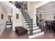 Elegant foyer with hardwood floors, staircase with wrought iron railings, and paneled walls at 1098 Matchstick Sw Pl, Concord, NC 28025