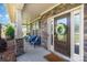 Inviting front porch with comfortable seating, stone accents, and decorative floral wreath at 1098 Matchstick Sw Pl, Concord, NC 28025