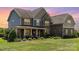 Beautiful two-story home with manicured lawn and lush landscaping at 1098 Matchstick Sw Pl, Concord, NC 28025
