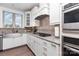 Modern kitchen showcasing stainless steel appliances, gas range, and granite countertops with tile backsplash at 1098 Matchstick Sw Pl, Concord, NC 28025