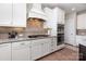 This kitchen features white cabinets, stainless steel appliances, granite countertops, and a gas range with range hood at 1098 Matchstick Sw Pl, Concord, NC 28025