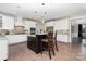 Spacious kitchen boasts white cabinets, stainless steel appliances, granite countertops, and a large center island with bar stools at 1098 Matchstick Sw Pl, Concord, NC 28025
