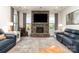 Comfortable living room with a stone fireplace, built-in features, and natural light at 1098 Matchstick Sw Pl, Concord, NC 28025