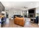 Spacious living room with a stone fireplace, hardwood floors, and abundant seating at 1098 Matchstick Sw Pl, Concord, NC 28025