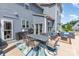 Back patio with an outdoor dining set, grill, and comfortable seating area at 1098 Matchstick Sw Pl, Concord, NC 28025