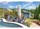 A refreshing pool area with patio seating and a shed in a lush backyard setting under a partly cloudy sky at 1098 Matchstick Sw Pl, Concord, NC 28025