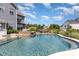Backyard with in-ground pool, a tanning ledge, and a stone waterfall feature, perfect for outdoor relaxation at 1098 Matchstick Sw Pl, Concord, NC 28025
