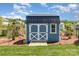 A well-maintained backyard shed with a charming design in a landscaped setting at 1098 Matchstick Sw Pl, Concord, NC 28025
