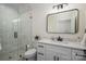 This bathroom features white cabinets, modern fixtures, and a tiled glass shower at 115 Woodward Way, Iron Station, NC 28080